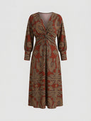 Amelia floral A-line midi wedding guest dress in red with gold botanical print, V-neckline, twisted-knot waist and bishop sleeves, front view.