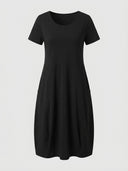 Amelia V-neck cap sleeve midi dress in black, relaxed A-line with front patch pockets, front view on white background.