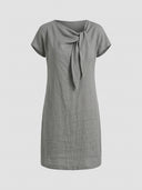 Beatrice cap sleeve bow detail mini dress in grey, front view showing structured sheath cut with asymmetric bow neckline.