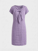 Beatrice cap sleeve bow detail mini dress in lilac, front view highlighting the fitted waist seam and asymmetric bow-knot neckline.