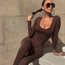 Brown seamless ribbed unitard jumpsuit with scoop neck, angled view.