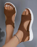 Brown knit slip-on flatform sandals with white platform sole, shown on feet from above angled view.