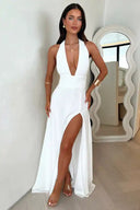 White maxi dress with deep V-neck, ruched waist, and high slit, front view.