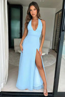 Light blue V-neck maxi dress with high slit, front view on a modern indoor background.