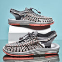 Gray and coral woven sandals with adjustable straps and cushioned sole, stacked pair view on blue background.