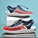 Carter unisex sandals in navy, red and white with lace-up straps, shown from side angles on light blue background.