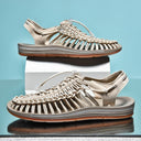 Beige woven strappy sandals with lace-up closure and cushioned sole, shown from side view.