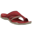 Red cushioned toe-post sandal with crossover forefoot strap and grey rubber outsole, angled side view.