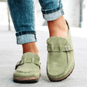 Green suede-look closed-toe platform mules with adjustable buckle strap and cushioned flatform sole, angled front view.