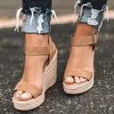 Open-toe espadrille platform wedge sandals in tan brown suede-look with wide forefoot band, buckle ankle strap, and braided jute wedge sole, front angled view.