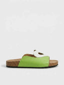 Light green heart cutout flatform slide sandal with white heart appliqué on wide strap and cork footbed, side view on white background.
