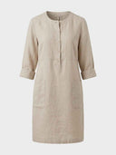 Daisy relaxed shift dress in oat woven, round crew neckline with partial button placket, three-quarter sleeves and two front patch pockets, front view.