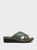 Green textured cross-strap wedge mule sandals with espadrille rope trim, brown footbed, and black lug sole, side view.