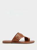 Brown cross-strap flat slide sandal with gold-tone buckle detail, angled view on white background.