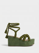 Olive green rope wedge sandals with ankle ties and tassels, side view.