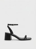 Black square-toe strappy sandals with adjustable silver-buckle ankle strap and low block heel, side view on white background.