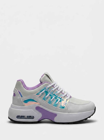 Chunky lace-up trainers in white and grey with iridescent teal holographic panels and purple accents, side profile view on white background.