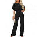 Black round neck jumpsuit with short sleeves and waist tie, front view.