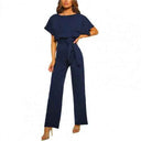 Navy blue round neck jumpsuit with short sleeves and waist tie, front view.