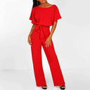 Red jumpsuit with boat neck, short sleeves, and waist tie, front angled view.