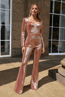 Rose gold sequin jumpsuit with sweetheart neckline, long sleeves, and flared legs, front view.