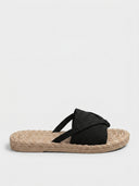Crossover knit slide sandals in Black — cushioned flat mule with espadrille-style sole.