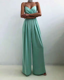 Mint green strapless jumpsuit with pleated wide-leg pants, front view on white background.