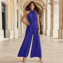 Royal blue pleated halter jumpsuit with wide legs and tie waist, front view.