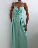 Mint green spaghetti strap jumpsuit with sweetheart neckline, front view on white background.