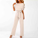 Cream jumpsuit with short sleeves and waist tie, front view on white background.