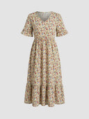 Cream floral midi dress with V-neck, ruffled sleeves, and tiered skirt, front view.