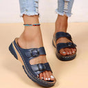 Blue platform wedge sandals with adjustable buckle straps, perforated upper detail, and chunky flatform sole, angled side view on neutral background.
