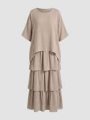 Beige tiered mini dress with short sleeves and round neck, front view.