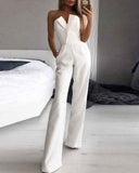 Red sleeveless one-piece jumpsuit with wide legs and V-neck detail, front view in a bedroom.