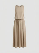 Tan sleeveless maxi dress with elastic waist and side slit, front view.