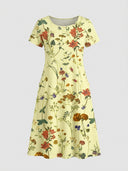 Yellow mini dress with colorful floral print, short sleeves, and pockets, front view on gray background.