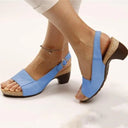 Blue peep-toe slingback sandals with cork block heel and buckle ankle strap, angled side view on model.