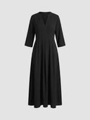 Black tiered maxi dress with V-neck and three-quarter sleeves, front view on a white background.