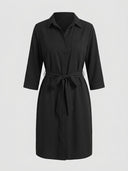 Black mini shirt dress with 3/4 sleeves, chest pocket, and tie waist, front view on neutral background.