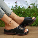 Brown cushioned slip-on wedge mule sandal with perforated forefoot strap and gold metal detail, angled side profile view.