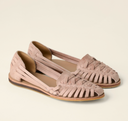 Pink closed-toe woven flat sandals with huarache strap upper and natural-edge outsole, angled three-quarter view.