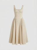 Beige sleeveless corset midi dress with full pleated skirt, front view on light background.