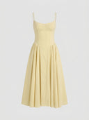 Pale yellow sleeveless corset midi dress with full skirt, front view.