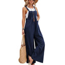 Navy blue flared jumpsuit with button straps, front view on white background.