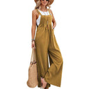 Mustard yellow flared jumpsuit with button straps and side pockets, front view.