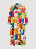 Colorful geometric floral print mini dress with collar and buttons, front view.