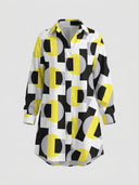 White mini dress with yellow, black, and gray geometric print, front view.