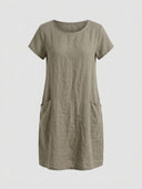 Olive green linen mini dress with short sleeves and two front pockets, front view.