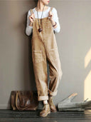 Full-body view of a person wearing a brown velvet wide-leg overall with front and back pockets.