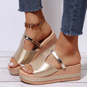 Gold metallic platform wedge sandal with buckle ankle strap and cushioned footbed, open-toe silhouette, front angled view.